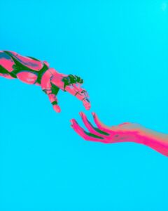 robot and human hands reaching toward each other